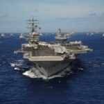 Aircraft carrier leads a naval fleet at sea