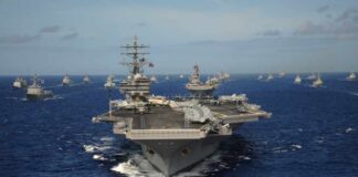 Aircraft carrier leads a naval fleet at sea