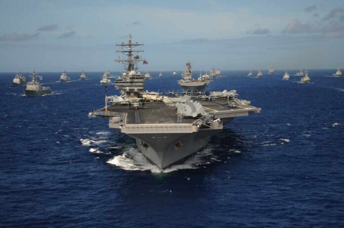 Aircraft carrier leads a naval fleet at sea