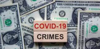 Dollar bills and wooden blocks saying COVID 19 crimes
