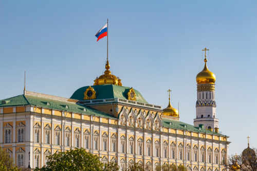 The Kremlin building with the Russian flag and golden domes in the background