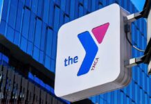 Nude Transgender Chaos at SF YMCA! YMCA sign mounted on a modern glass building
