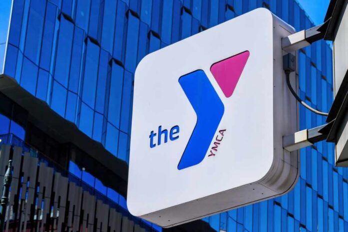 YMCA sign mounted on a modern glass building