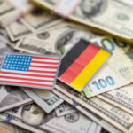 USA and Germany flags on various currencies