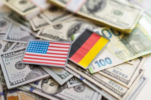 USA and Germany flags on various currencies