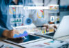 AI Savings Dream Becomes Expensive Reality Person analyzing data on tablet and laptop.