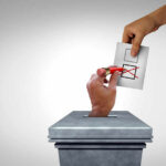 Ballot being erased as its placed into box.