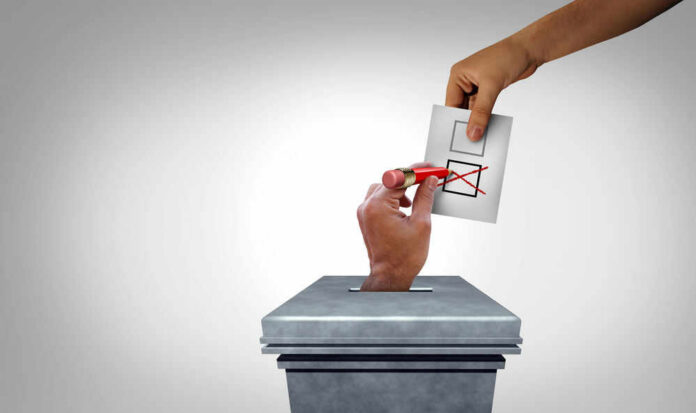 Ballot being erased as its placed into box.