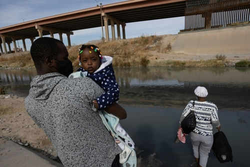 haiti-immigrant2120438225jpg-1 Man carrying child near a body of water