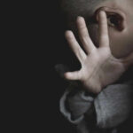The Scandal Authorities Couldn’t Ignore Forever Child covering face with hand in dim light