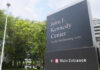 Sign for the John F. Kennedy Center for the Performing Arts with trees in the background