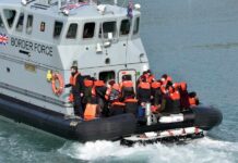 Belfast Attack Sparks Border Scrutiny Border Force boat with migrants wearing life jackets