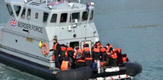 Border Force boat with migrants wearing life jackets