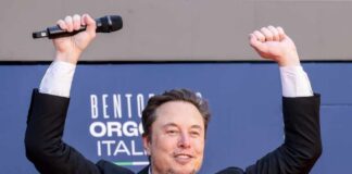 Person with a microphone raising hands in celebration