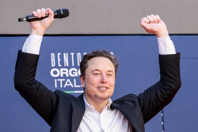 Person with a microphone raising hands in celebration