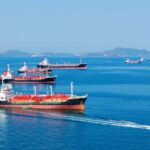 Several cargo ships navigating in a calm ocean