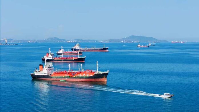 Several cargo ships navigating in a calm ocean