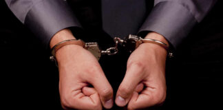 Hands in handcuffs, symbolizing arrest or detention
