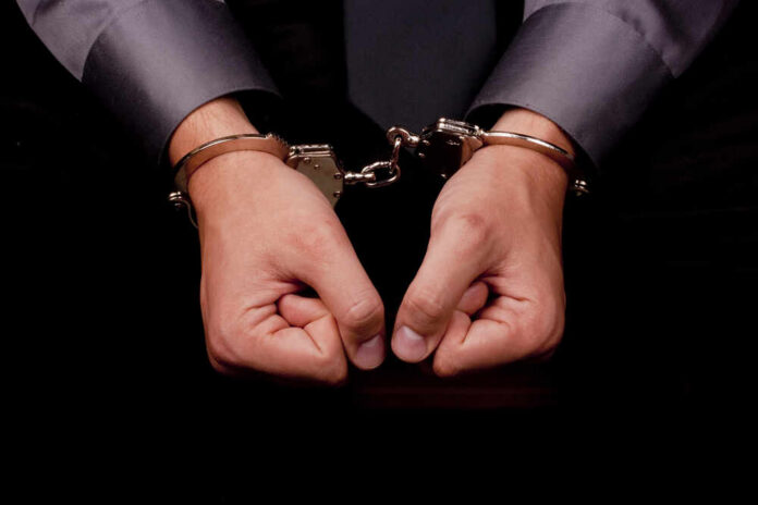 Hands in handcuffs, symbolizing arrest or detention