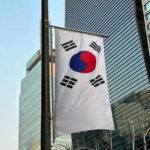 South Korean flag hanging among tall buildings