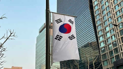South Korean flag hanging among tall buildings