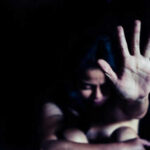 Person holding hand up in dark space