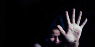 Person holding hand up in dark space