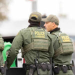 Big Hauls, Bigger Question: Are Cartels Winning? Border patrol officers standing with equipment outside