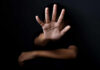 Person with open hand raised toward camera