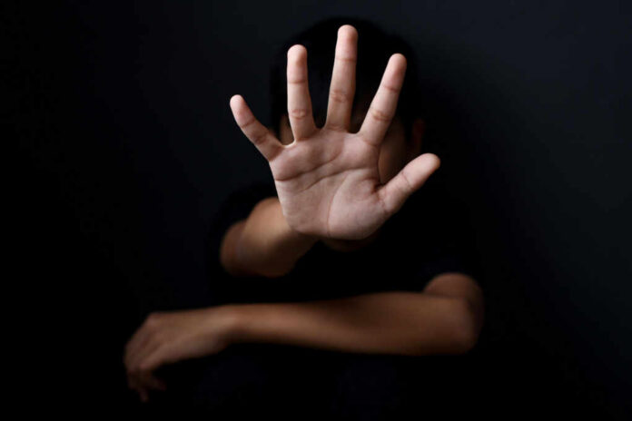 Person with open hand raised toward camera