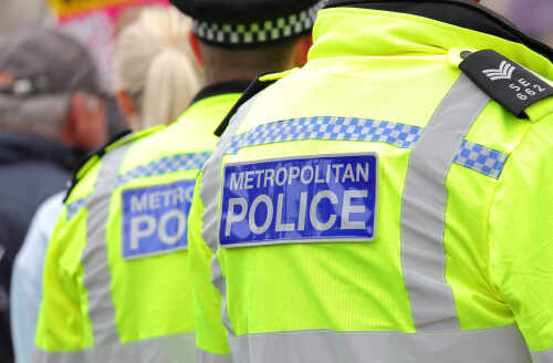 Two police officers in high-visibility jackets at a public event