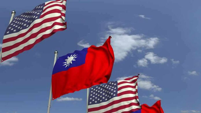 Flags of the United States and Taiwan waving against a blue sky