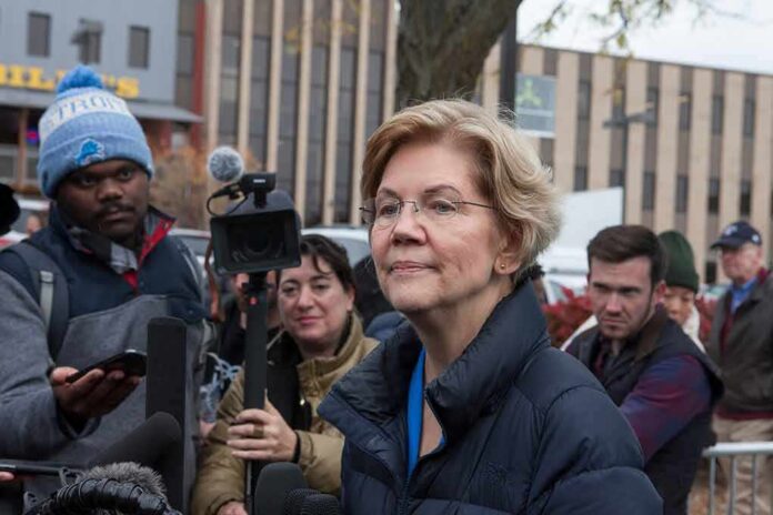 woman in glasses speaking to reporters outdoors