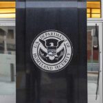 U.S. Department of Homeland Security emblem on building entrance
