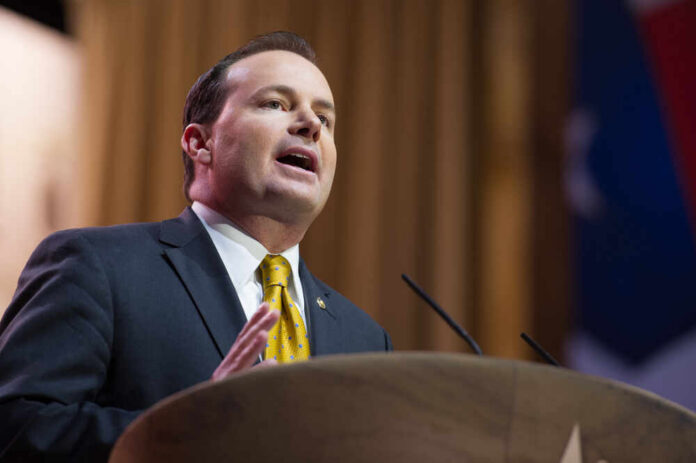 National,Harbor,,Md,-,March,6,,2014:,Senator,Mike,Lee A man in a suit delivering a speech at a podium
