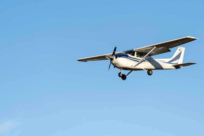 shutterstock_2136488743 Single-engine airplane flying against clear blue sky