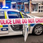 Police car with a 'Do Not Cross' tape in front