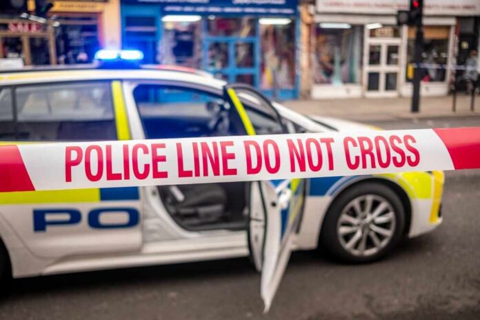 Police car with a 'Do Not Cross' tape in front