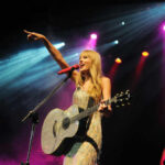 Private Event Draws Extraordinary City Resources Singer with acoustic guitar performing on stage