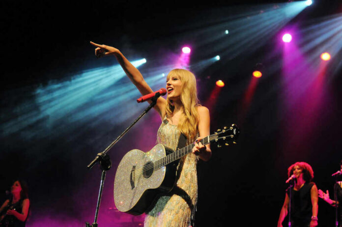 taylor-swift-during-her-show758842915jpg Singer with acoustic guitar performing on stage