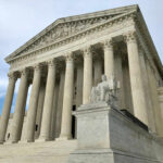 United States Supreme Court building with columns and statue