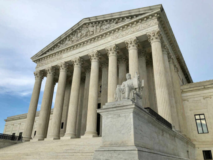 United States Supreme Court building with columns and statue