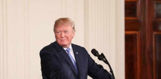 man at podium with presidential seal
