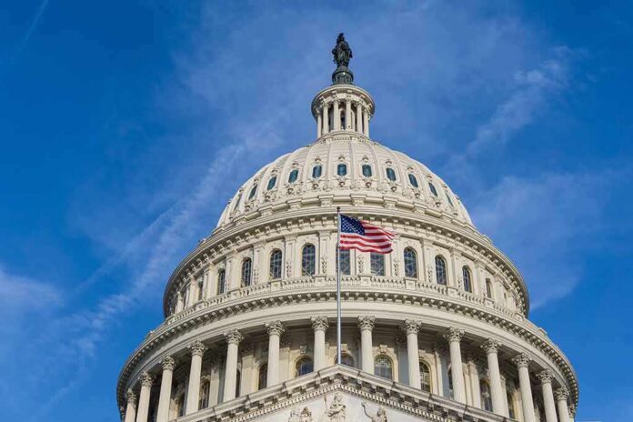shutterstock_1108348019-1 United States Capitol dome with American flag