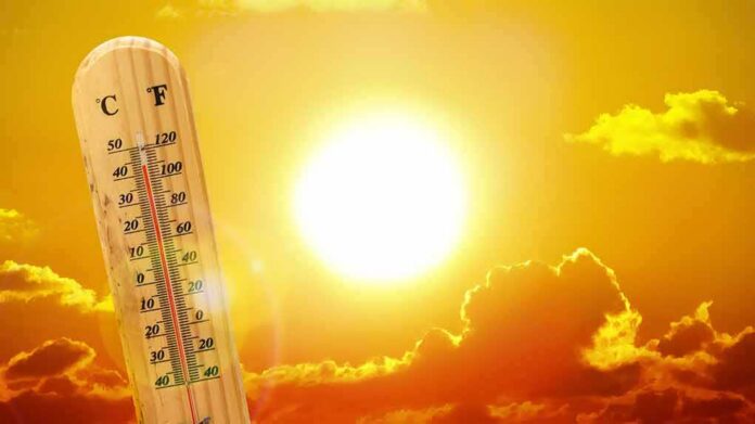 thermometer in front of a blazing sun and orange sky
