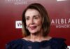 Pelosi Filing Reveals A Seven-Figure Market Move woman in navy lace dress on red carpet