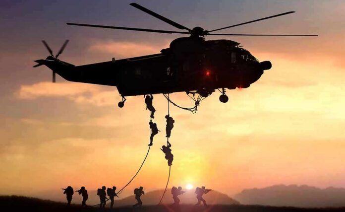 shutterstock_1384490141 military helicopter with soldiers fast-roping at sunset