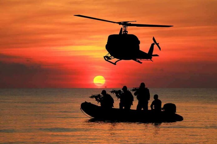 Helicopter hovers above armed team in inflatable boat at sunset