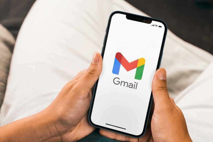 shutterstock_2104576556 Hands holding a smartphone displaying the Gmail app logo