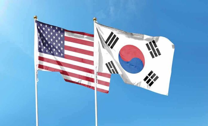 United States and South Korea flags waving against a clear blue sky